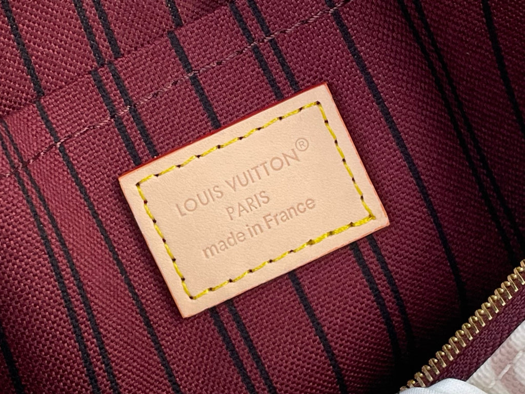 Louis Vuitton brand patch on red striped lining with gold-tone zipper trim
