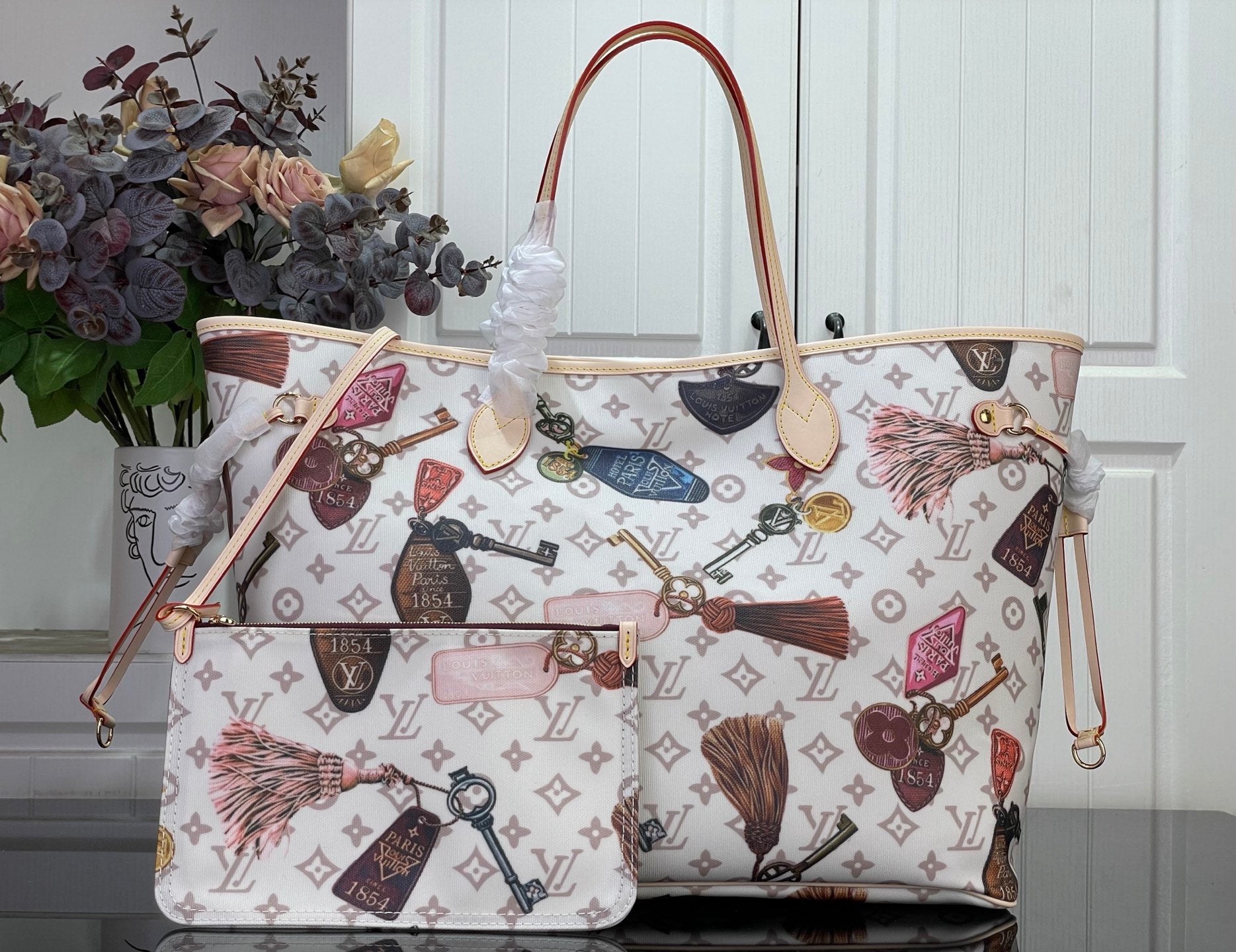 Louis Vuitton tote bag with multicolor logo print and brown leather handles
