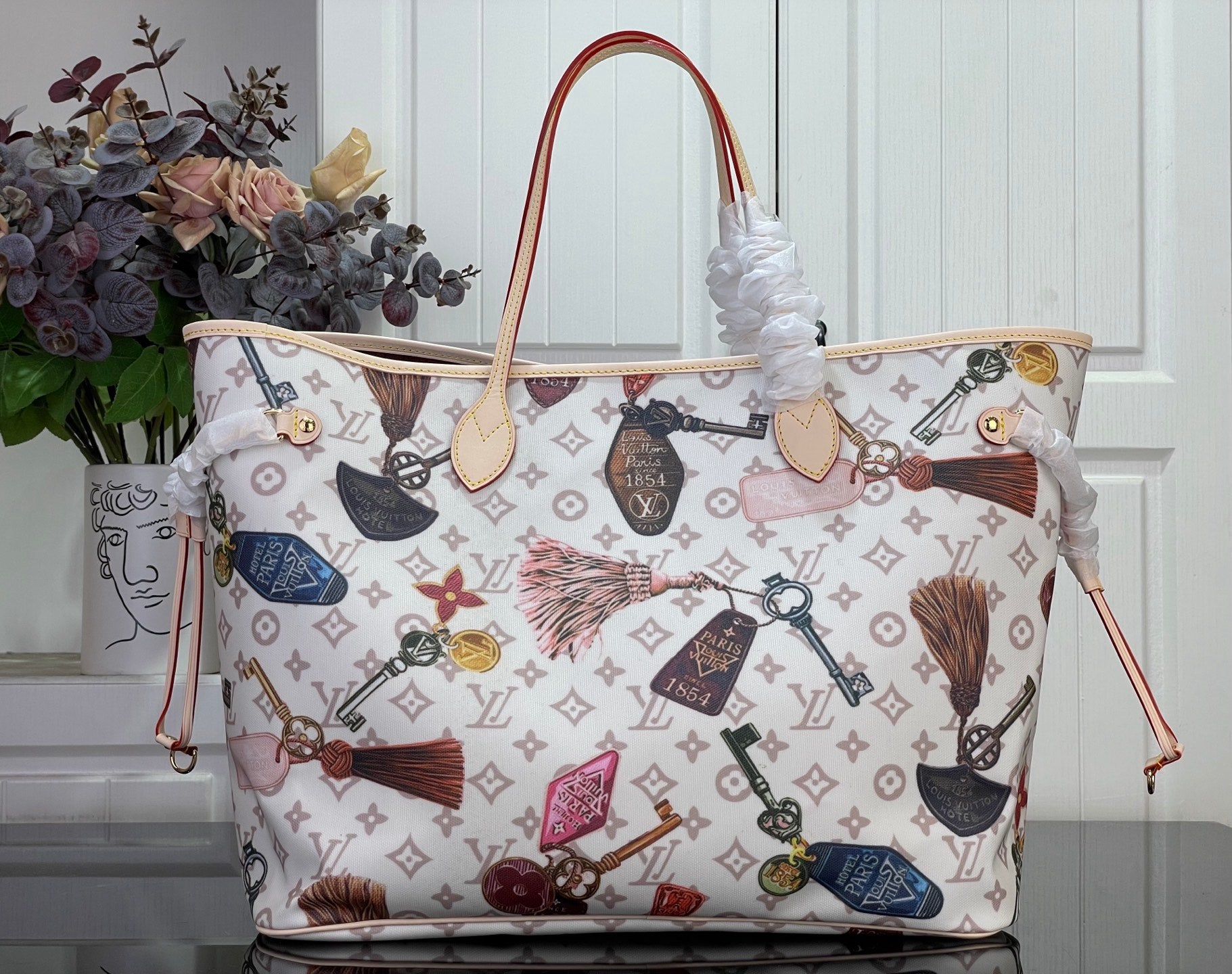 Louis Vuitton tote bag with multicolor motif print and leather handles