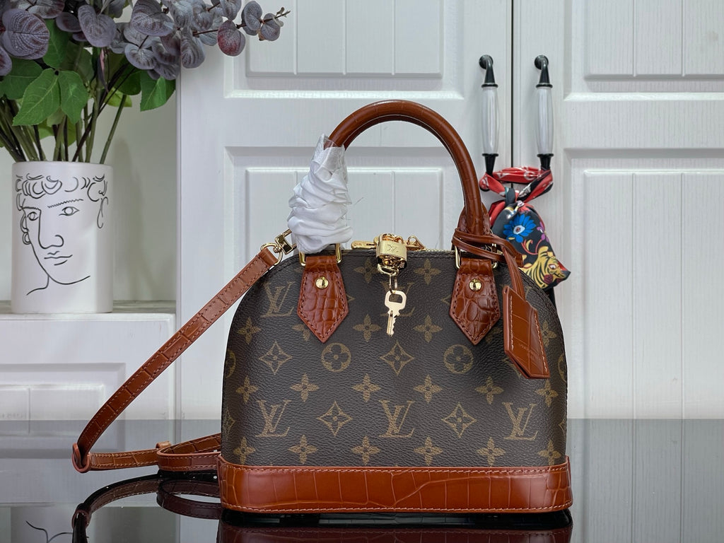Louis Vuitton monogram tote bag with brown leather trim and top handles