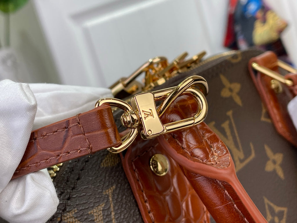 Louis Vuitton croc leather strap with gold hardware clasp and monogram backing