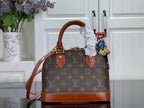 Louis Vuitton monogram handbag with brown leather handles and shoulder strap