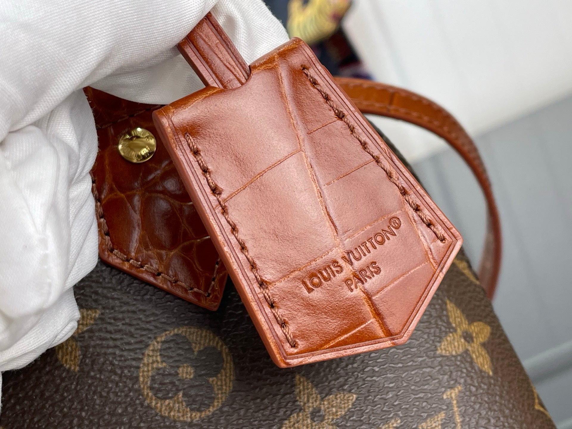 Louis Vuitton croc-embossed leather mini pouch with brown strap and gold clasp