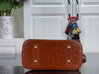Louis Vuitton croc-embossed leather pouch bag in brown with top zipper