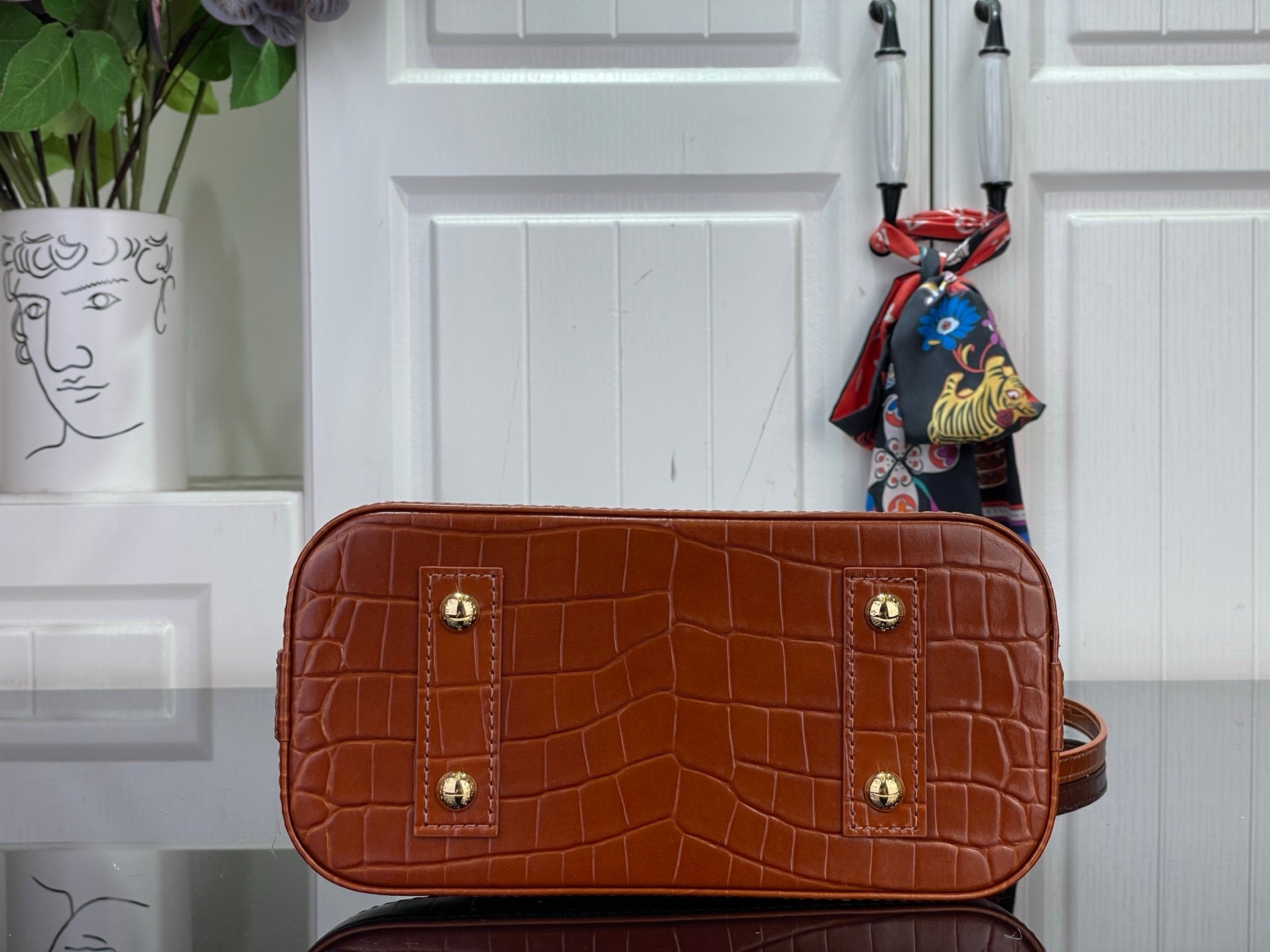 Louis Vuitton croc-embossed leather pouch bag in brown with top zipper