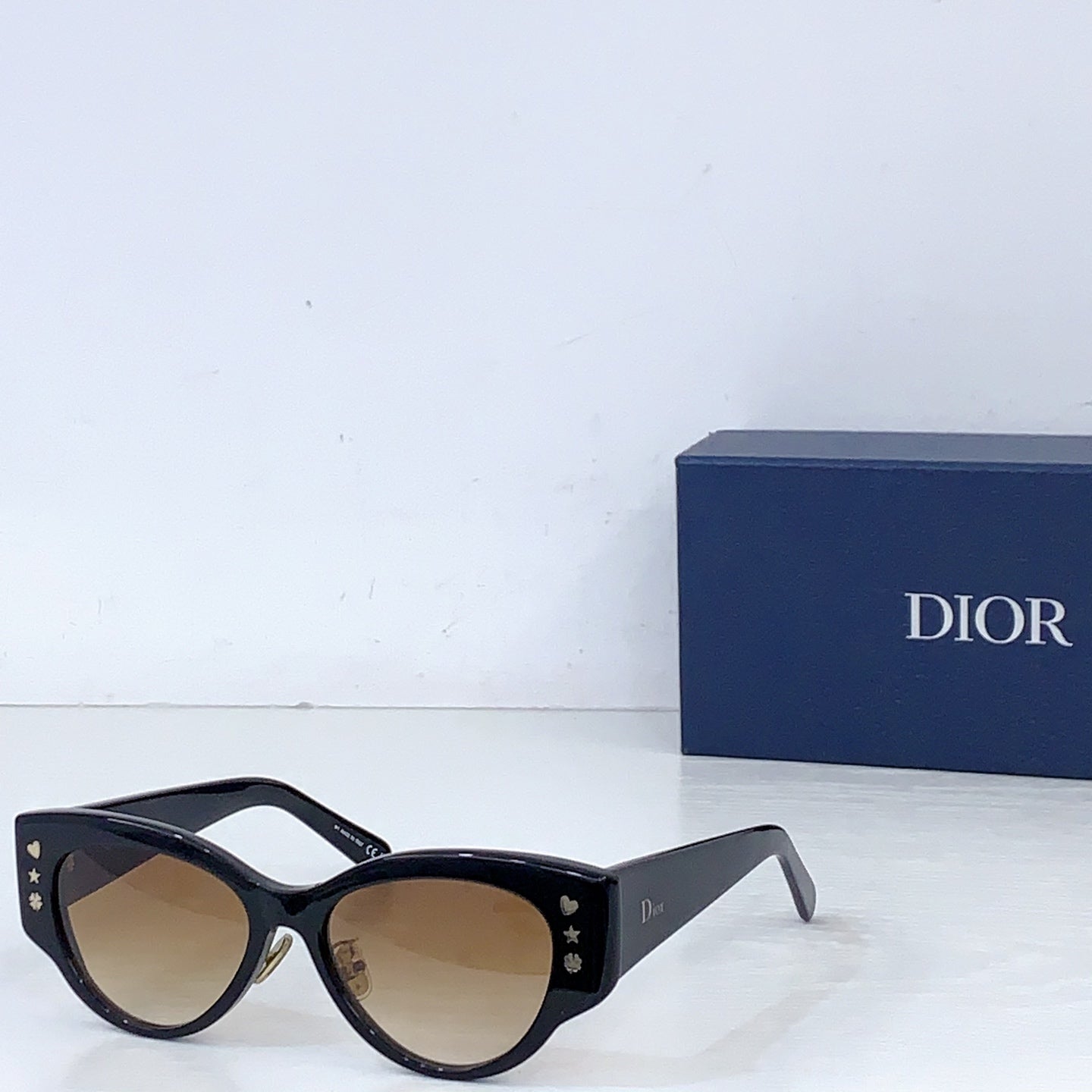 Dior cat-eye sunglasses with black frames and beige tint lenses