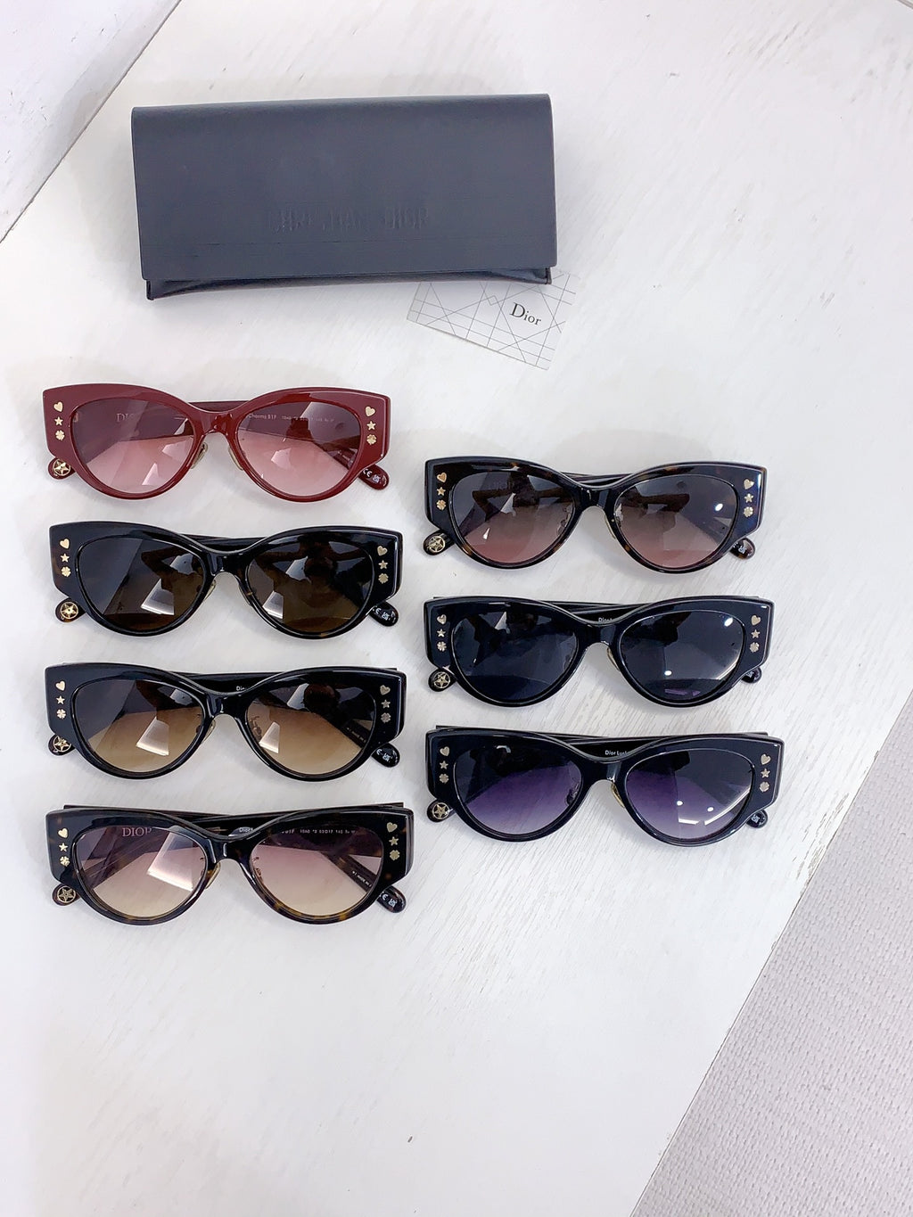 Dior cat-eye sunglasses assortment with red, black, and dark lenses on display