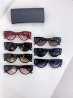 Dior cat-eye sunglasses assortment with red, black, and dark lenses on display