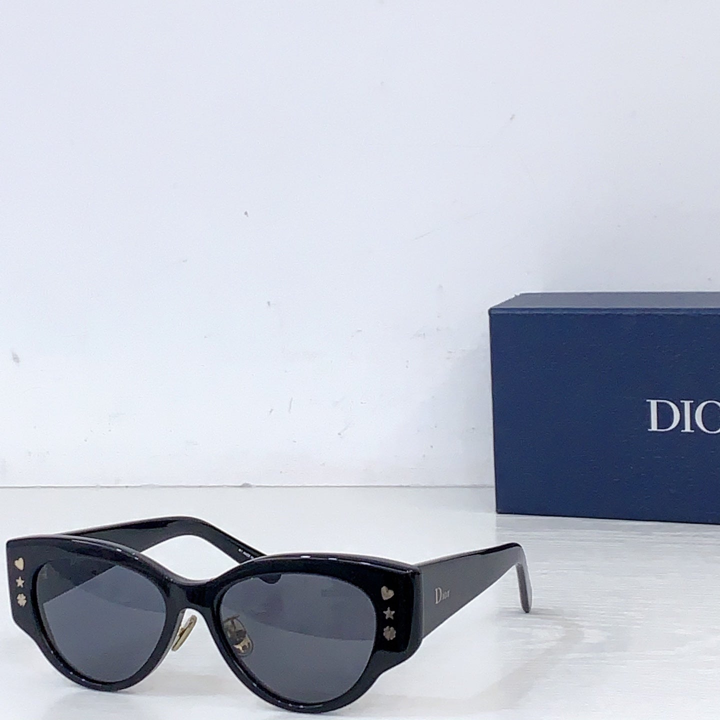 Dior cat-eye sunglasses with black frames and dark gray lenses