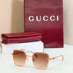 Gucci square sunglasses with gold frame and amber tinted lenses, with gold-tone chain temples.