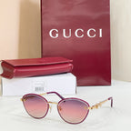 Gucci round sunglasses with pink mirrored lenses, gold-tone frame, logo detail on arms