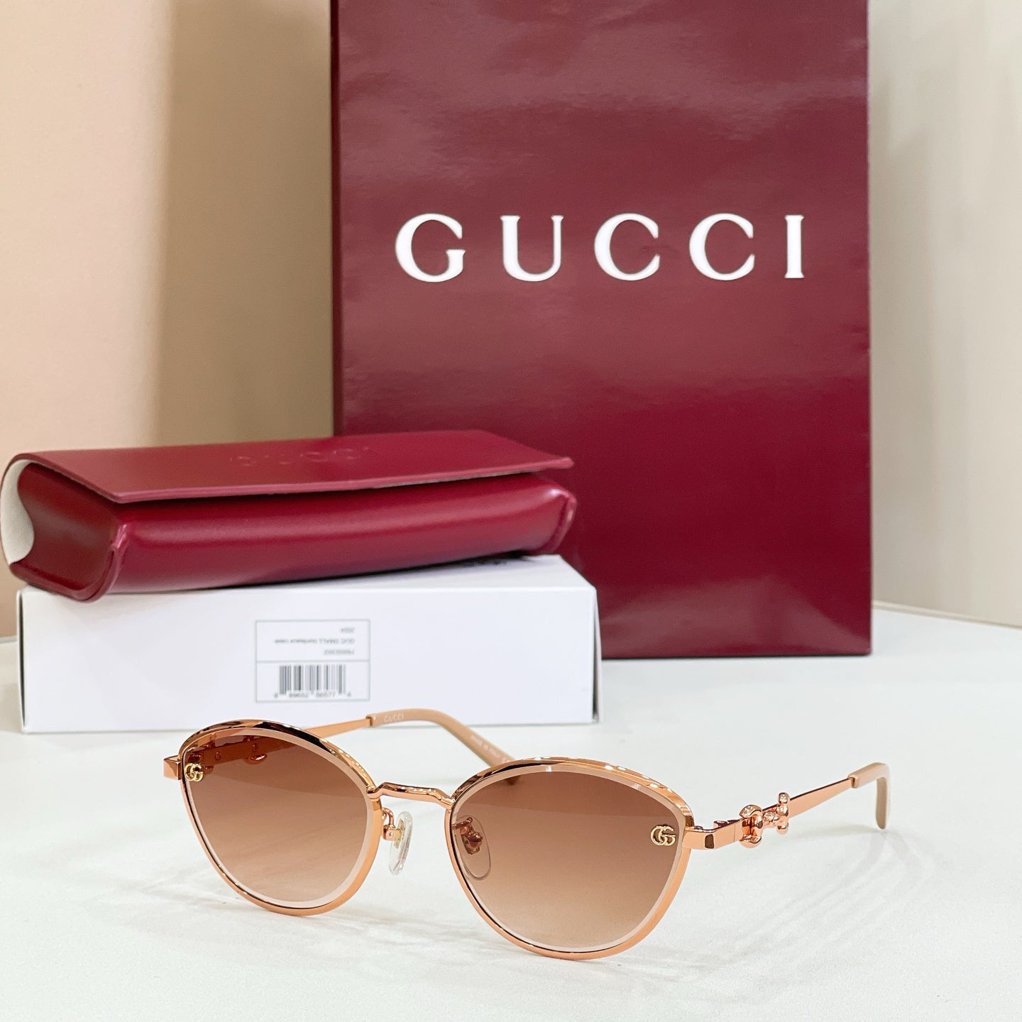 Gucci round sunglasses with brown lenses, gold-tone frame, delicate logo detail on arms