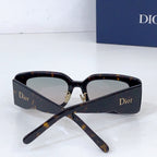 Dior sunglasses with dark tortoiseshell frame and light lenses, folded at the arms