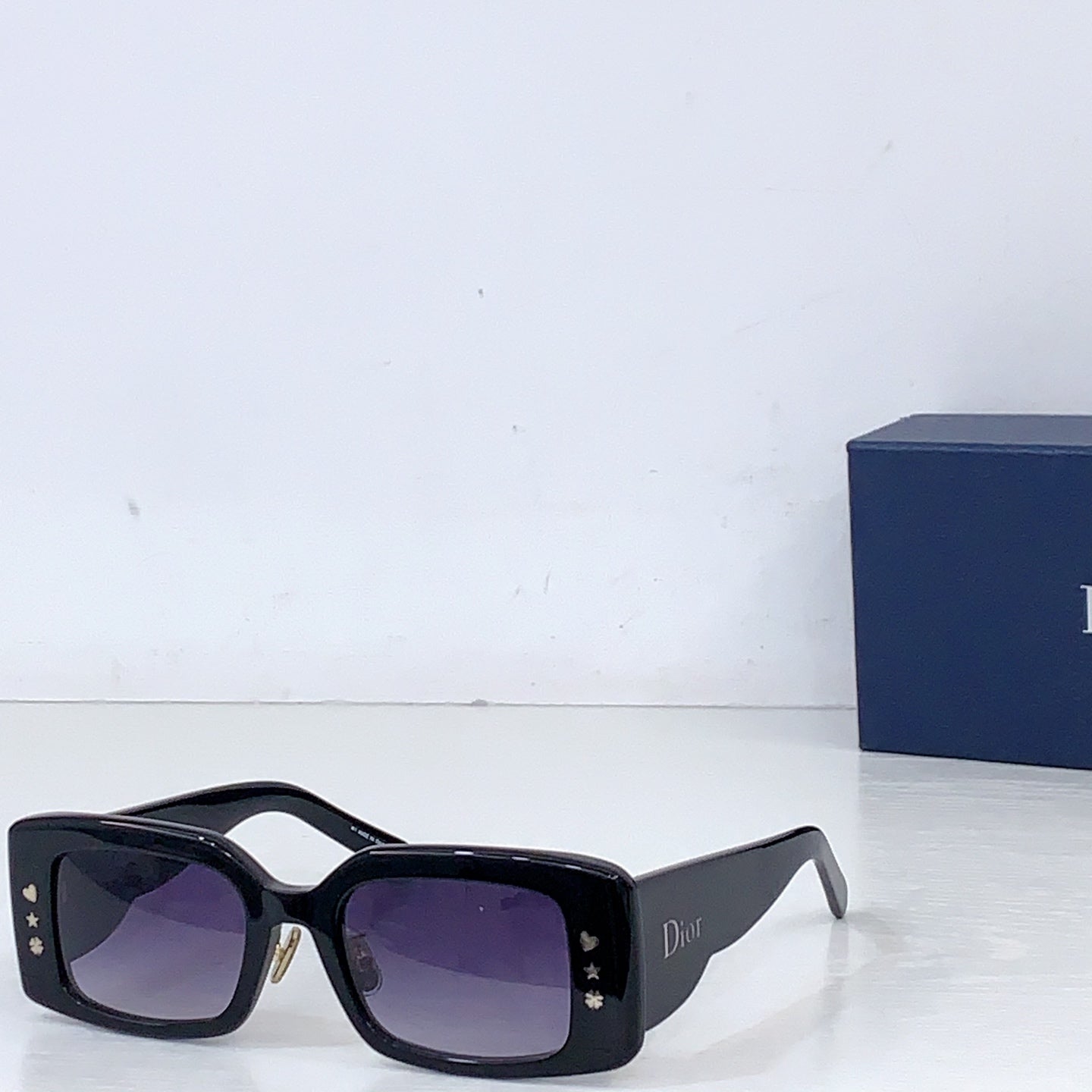 Dior square sunglasses with black frame and purple-tinted lenses