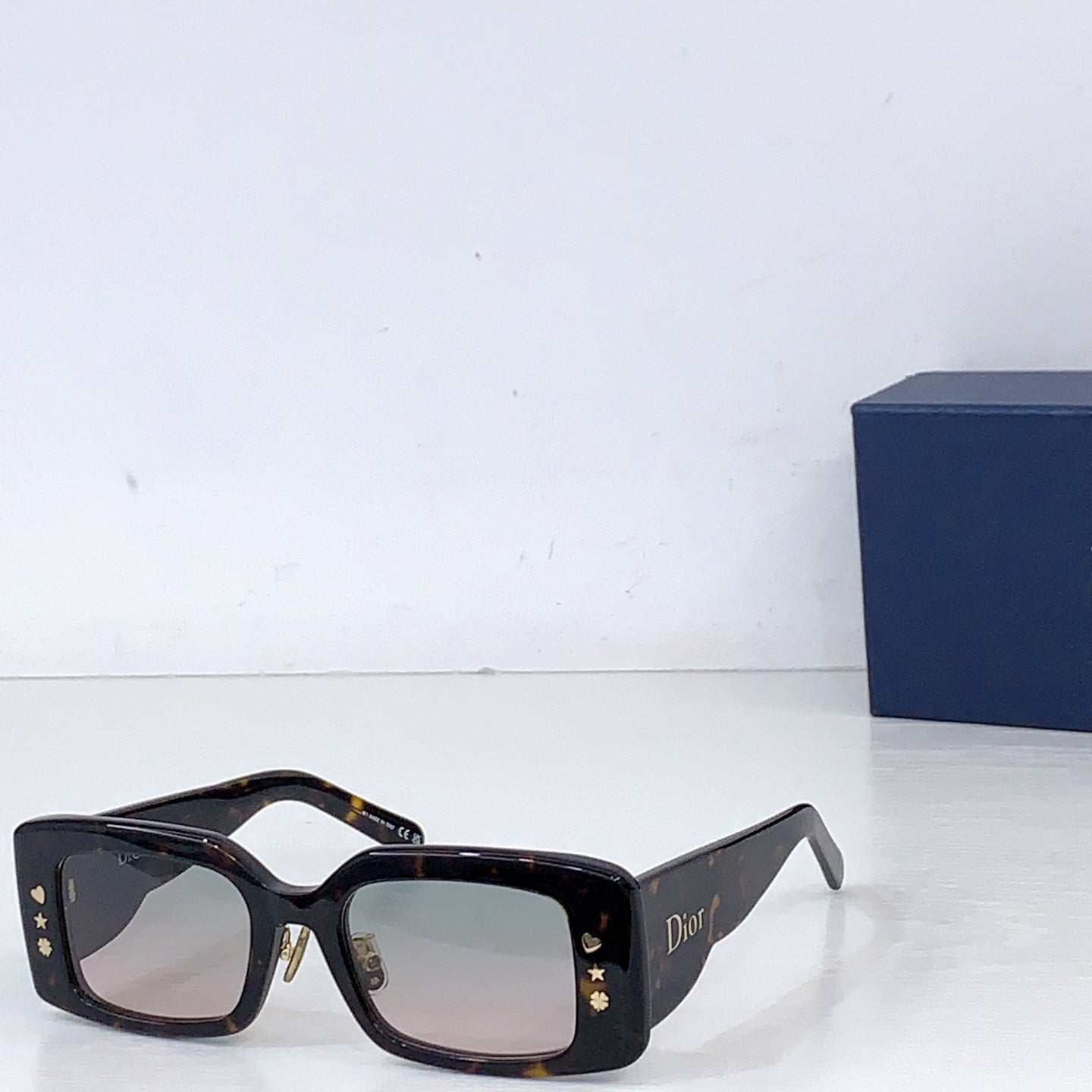 Dior square sunglasses with tortoiseshell frame and green-tinted lenses