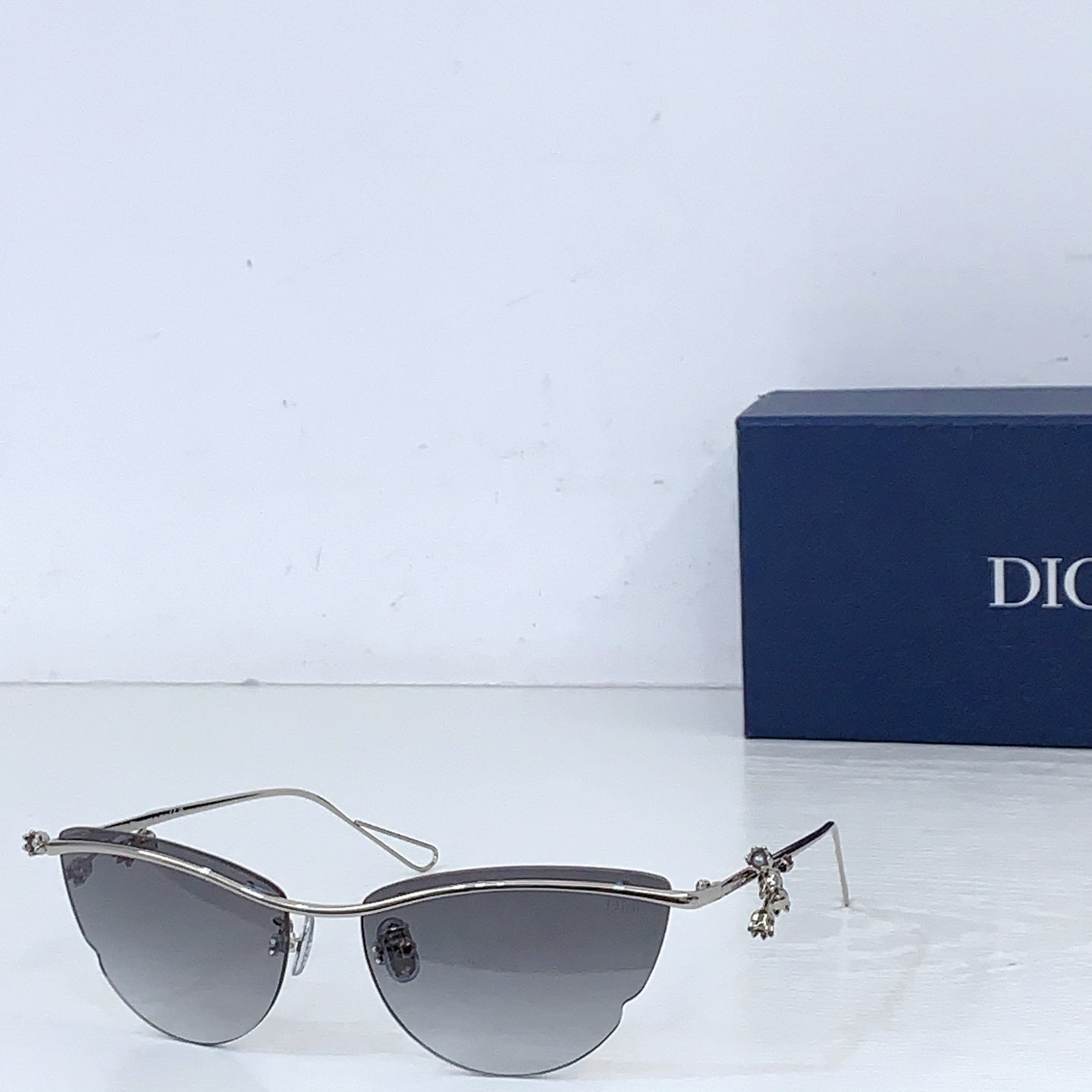 Dior sunglasses with silver-tone frame and dark gray tinted lenses
