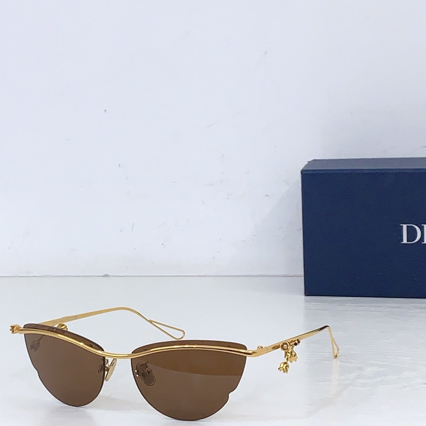 Dior sunglasses with gold-tone frame and brown tinted lenses
