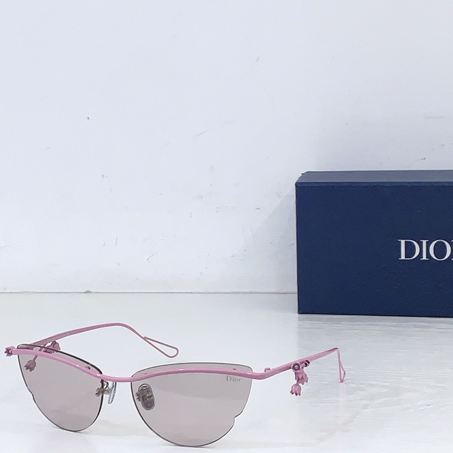 Dior sunglasses with pink frame and light brown tinted lenses