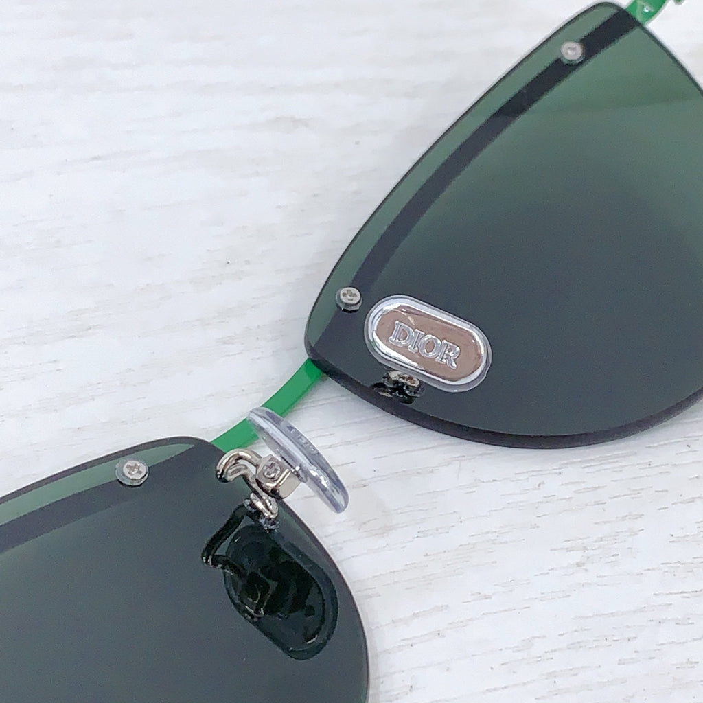 Dior sunglasses close-up of dark tinted lens with Dior logo detail