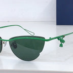 Dior sunglasses with green frame and small decorative charm on the temple