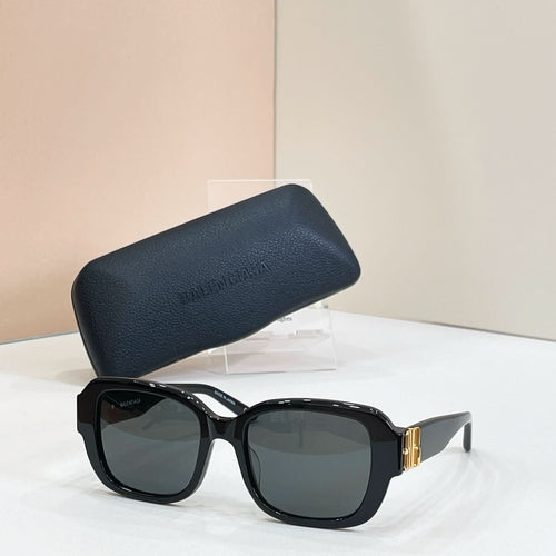 Square sunglasses with black frames and dark green tinted lenses, gold hinge detail