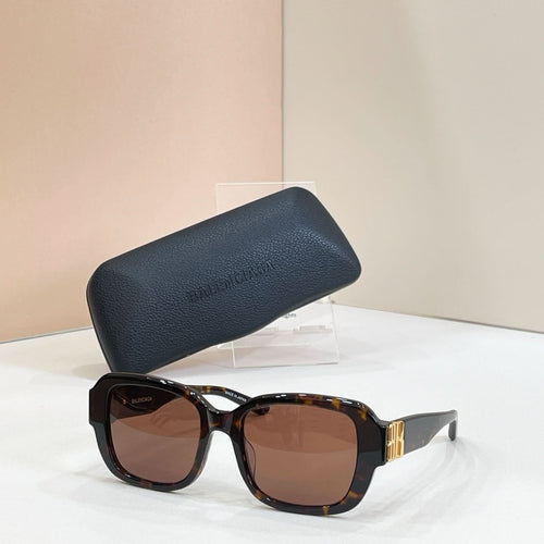 Square sunglasses with black frames and brown tinted lenses, gold hinge detail