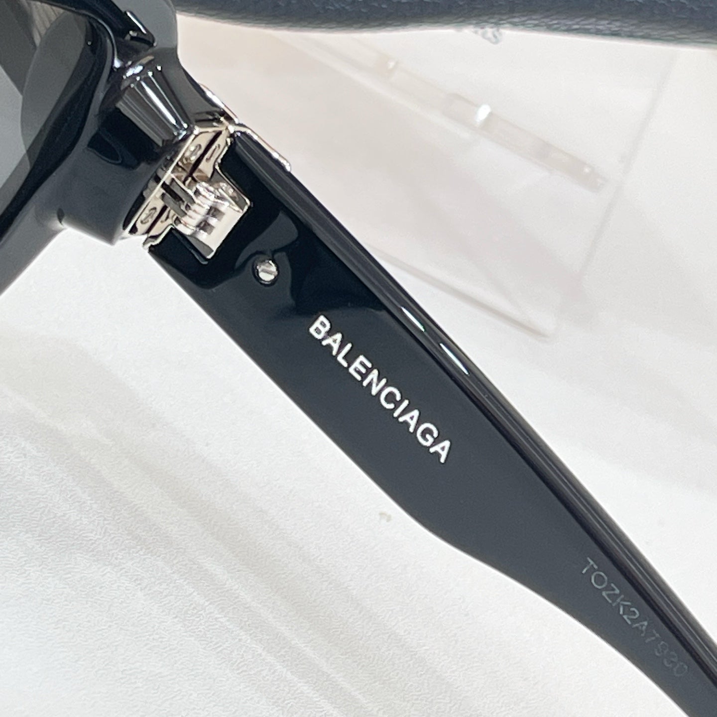 Sunglasses temple with BALENCIAGA text and metal hinge detail