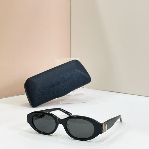 Balenciaga sunglasses with black frames and dark lenses, with matching dark case