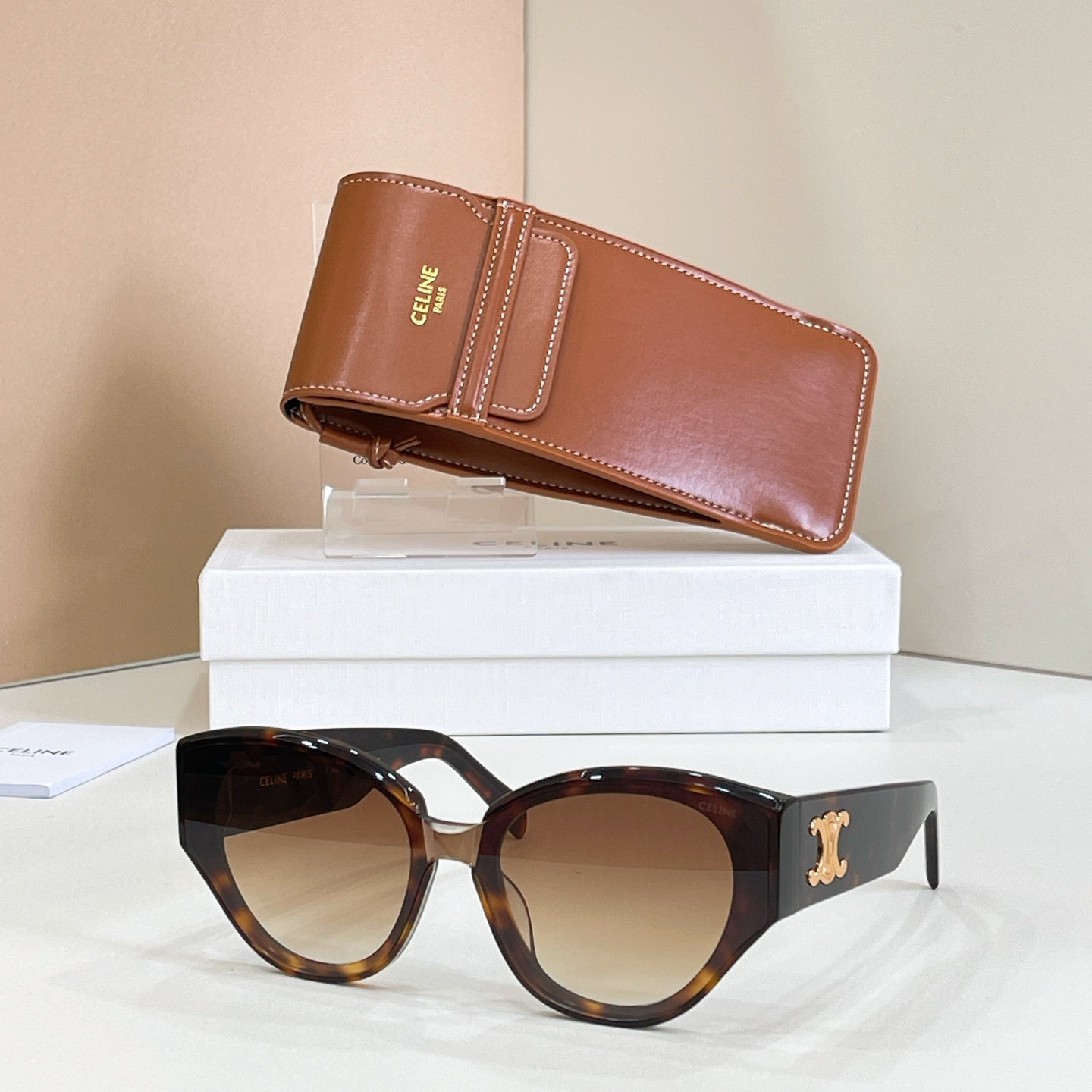 Tortoiseshell cat-eye sunglasses with gold Celine logo and amber tinted lenses