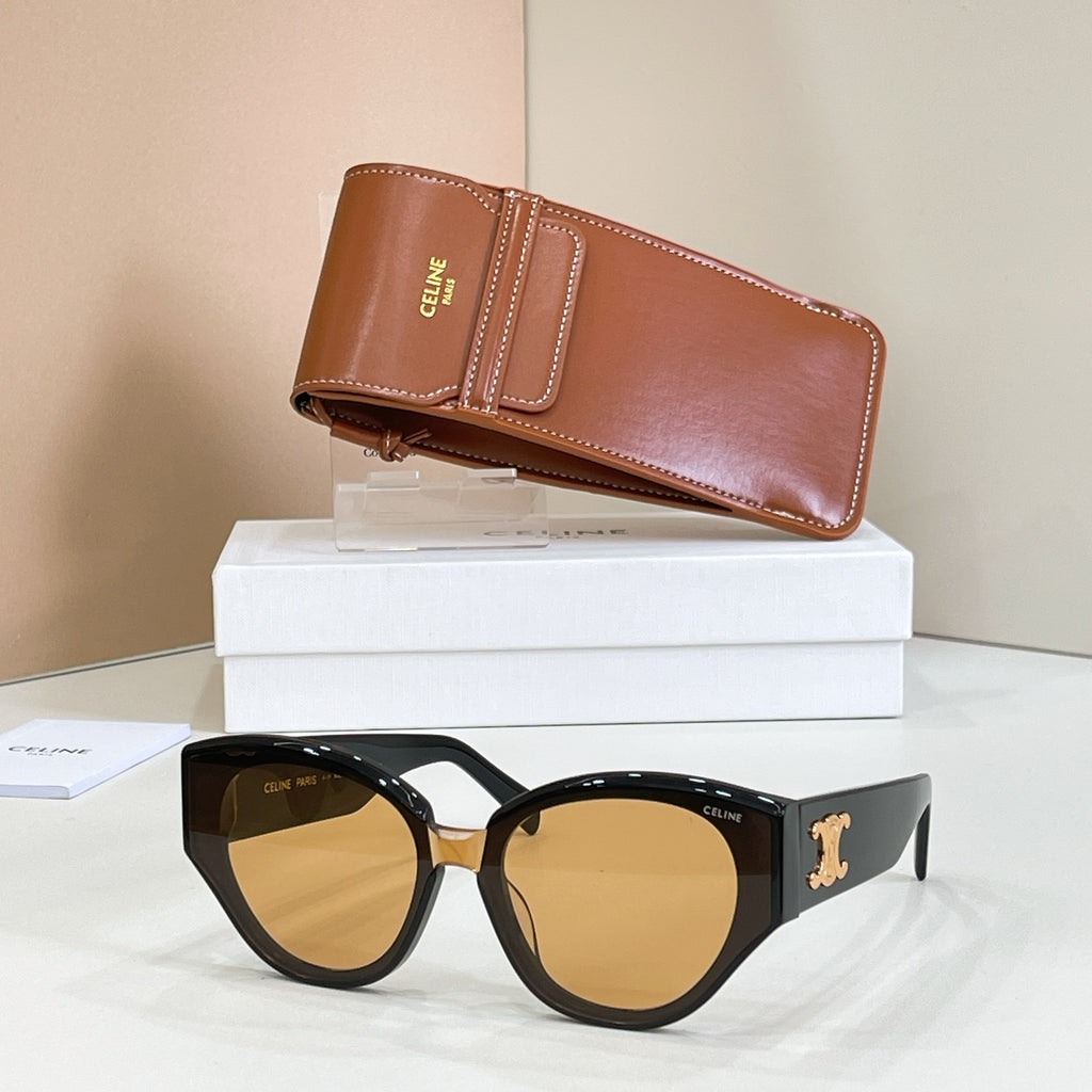 Rounded cat-eye dark sunglasses with gold Celine logo and amber tinted lenses