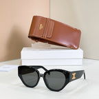 Cat-eye black sunglasses with gold Celine logo and dark tinted lenses