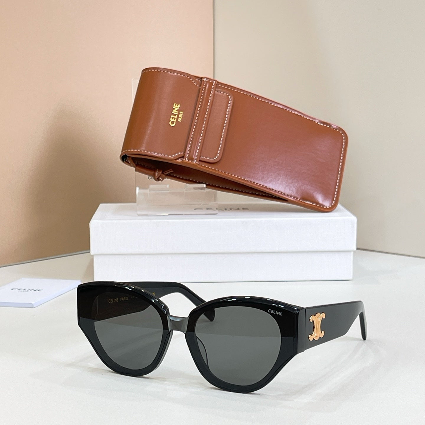 Cat-eye black sunglasses with gold Celine logo and dark tinted lenses