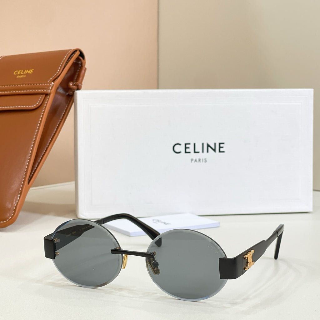 Gold-tone round sunglasses with gray-black lenses and dark temple arms