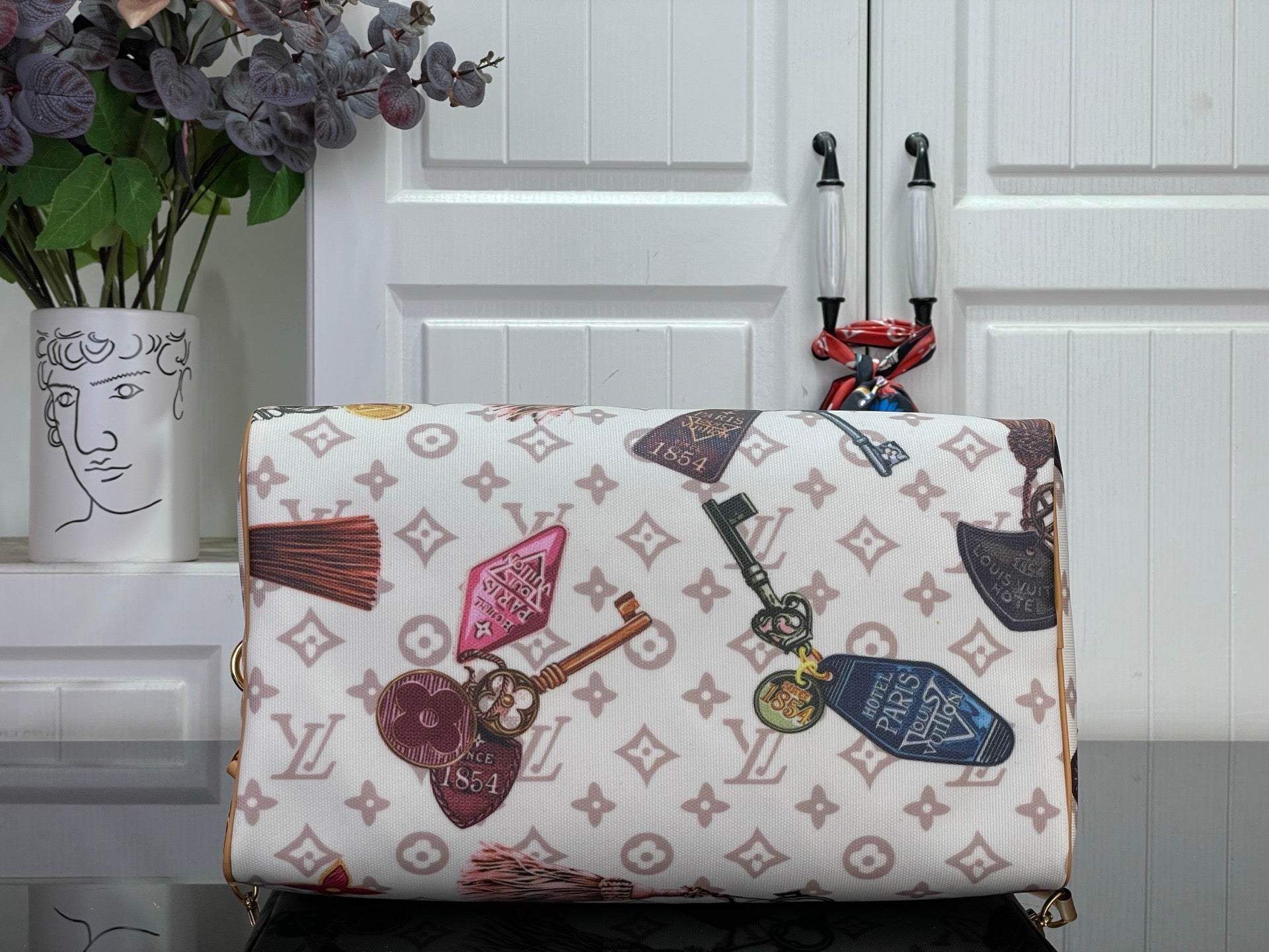 Louis Vuitton monogram tote handbag with top handles and front zipper closure