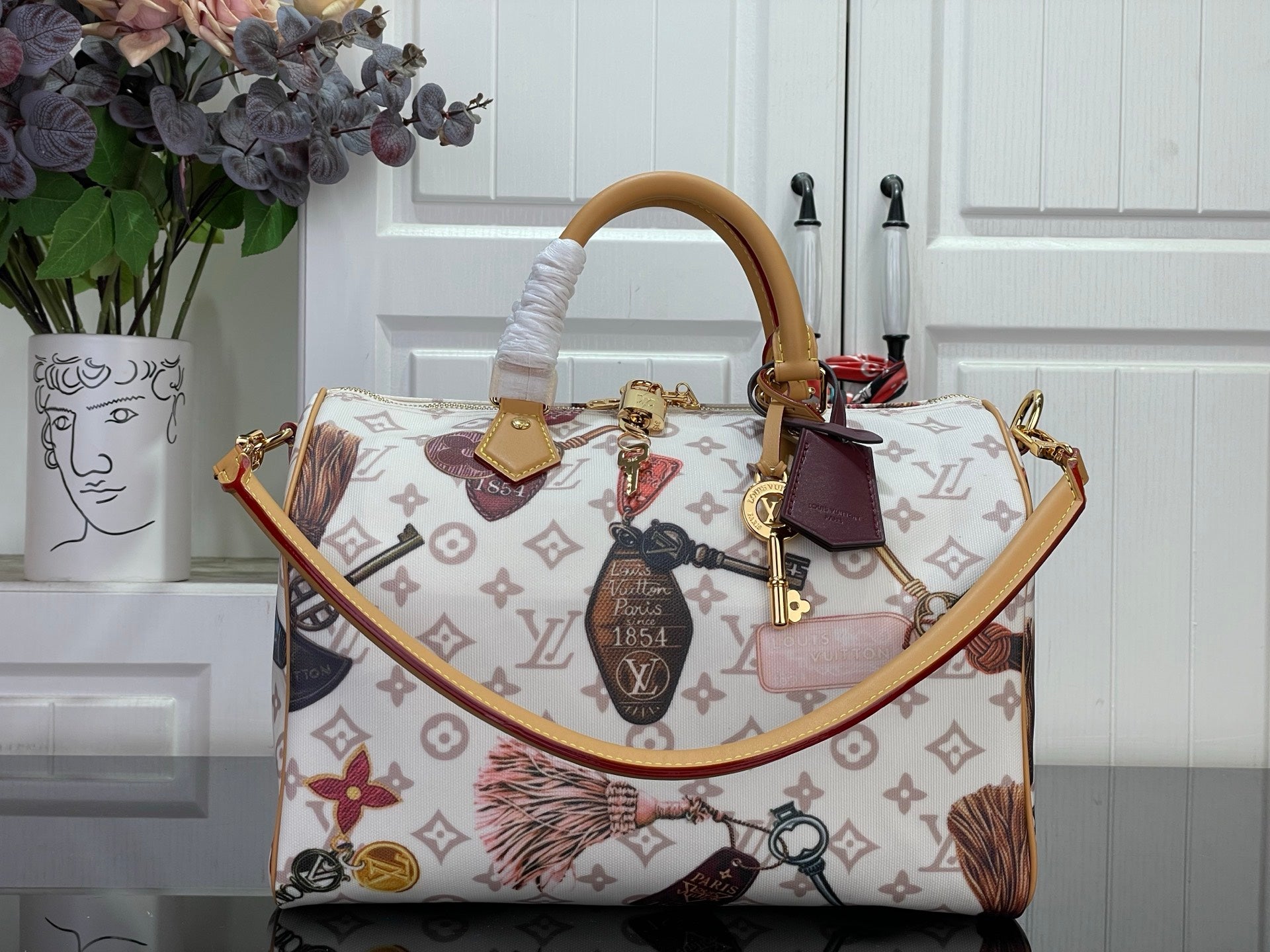 Louis Vuitton monogram tote handbag with top handles and colorful charm details