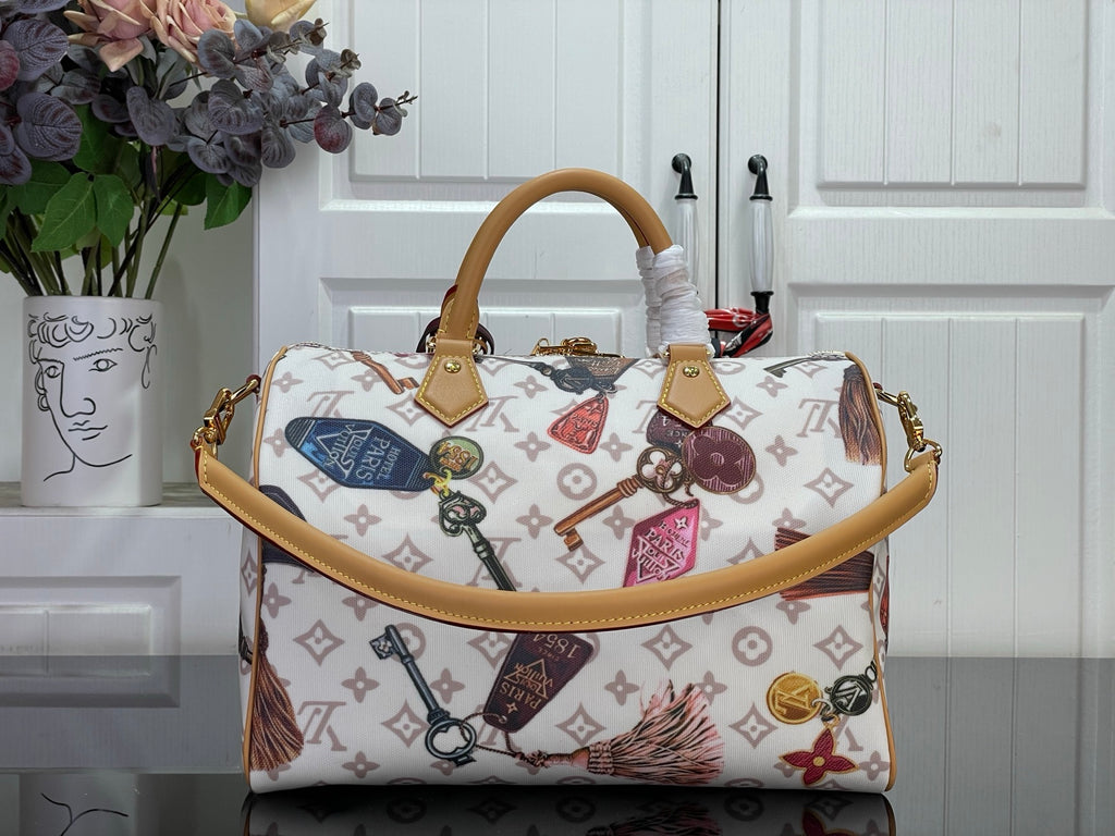 Louis Vuitton monogram tote handbag with two top handles and hanging accessories