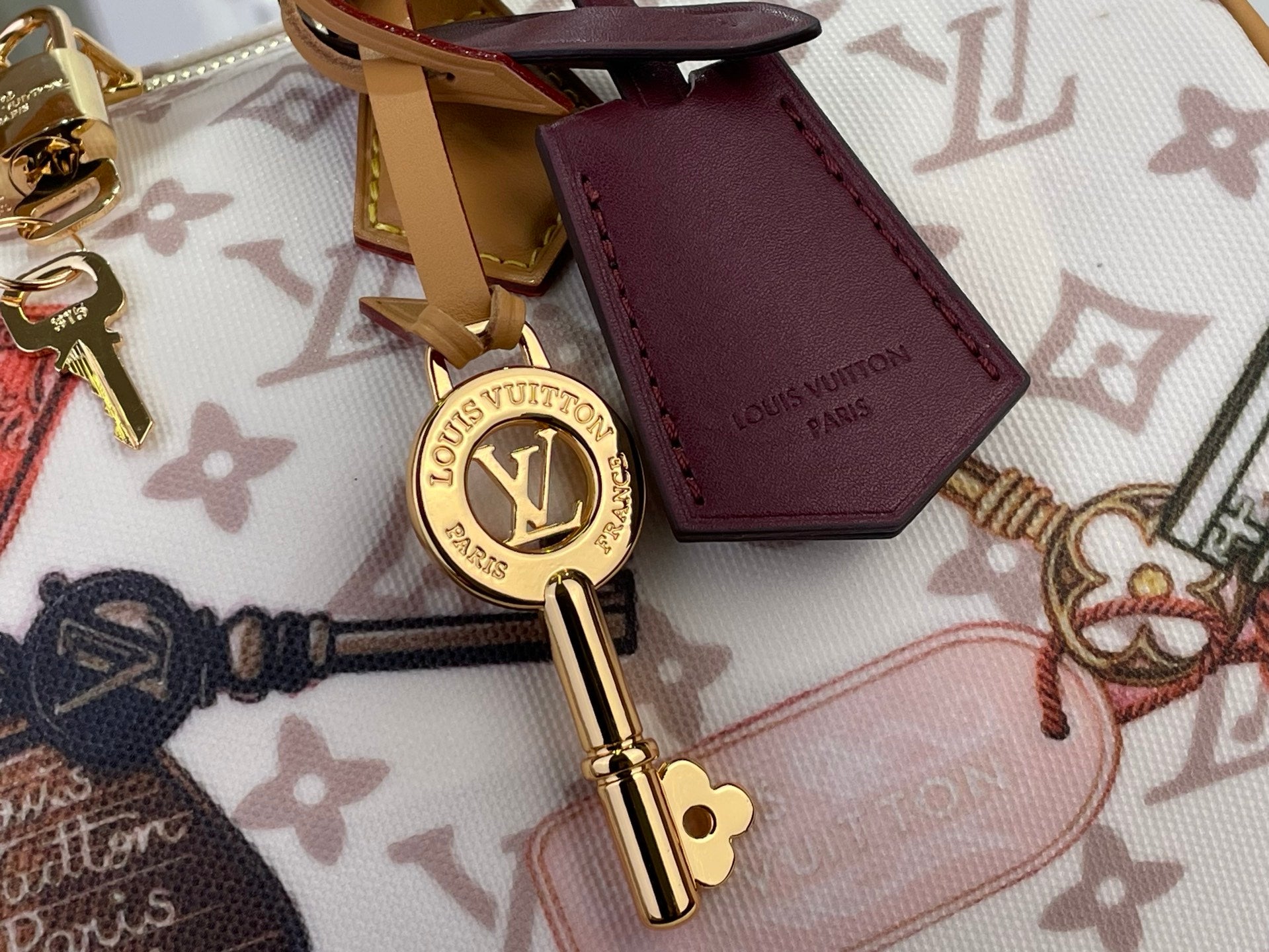 Louis Vuitton charm set on monogram handbag: key holder and burgundy card case