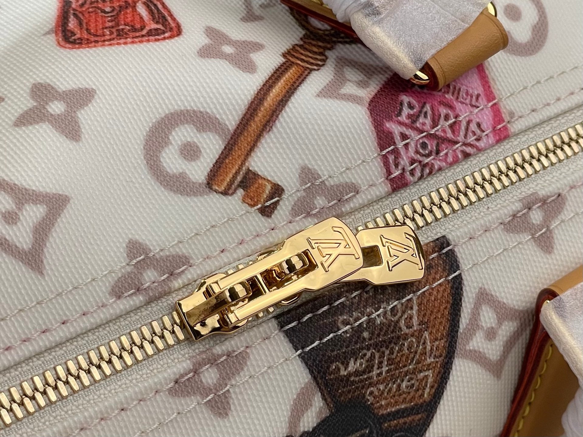 Louis Vuitton zipper pull and track with gold hardware on monogram handbag