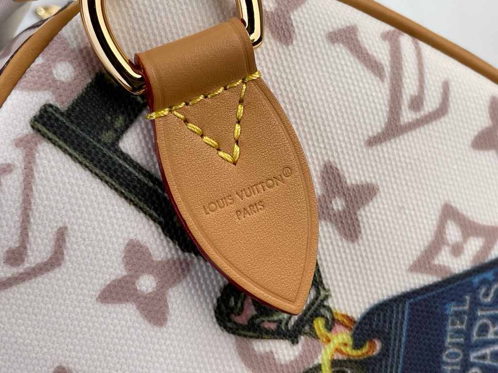 Louis Vuitton leather strap tab with logo on monogram handbag, stitched edge detail