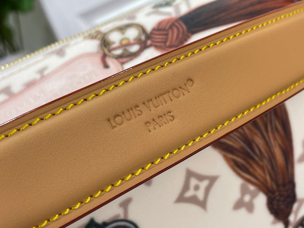 Tan leather strap embossed with Louis Vuitton Paris text and yellow edge stitching