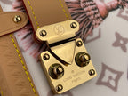 Louis Vuitton padlock charm on tan leather tab with gold-tone hardware over monogram fabric