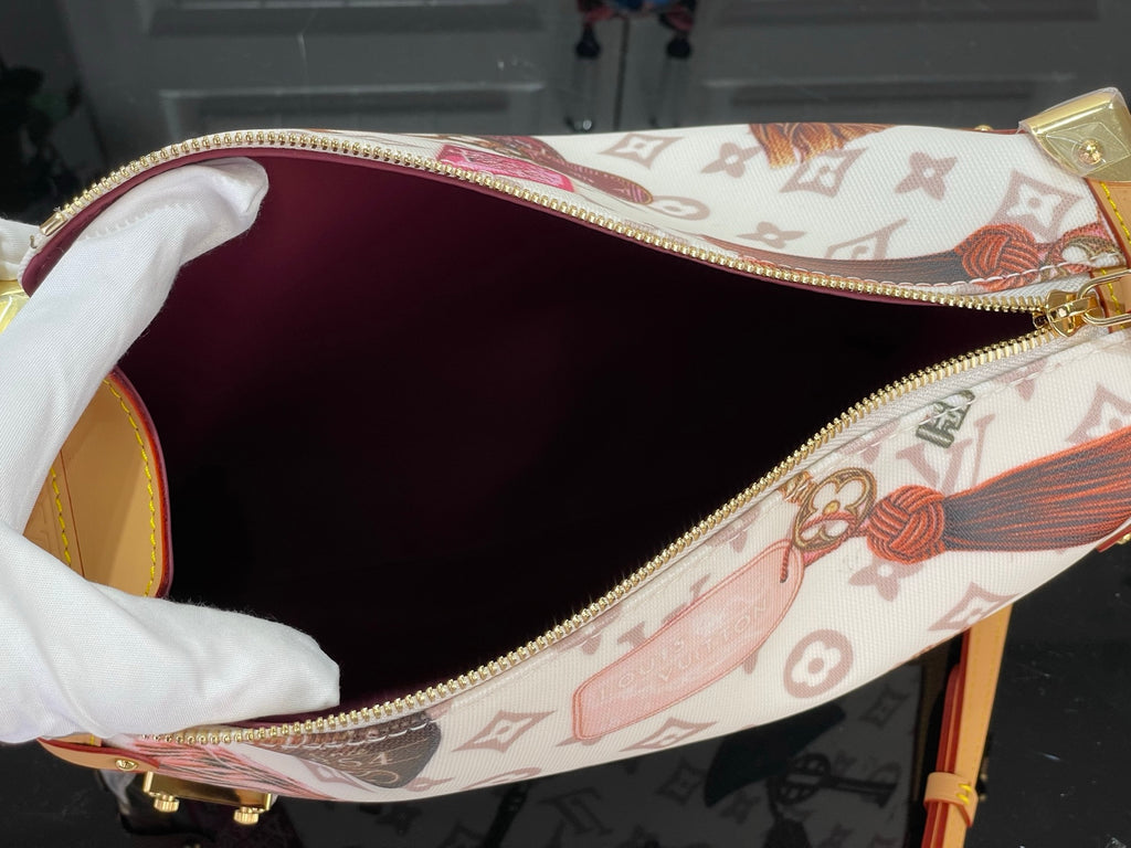 Monogram handbag interior with zip-top opening and burgundy fabric lining