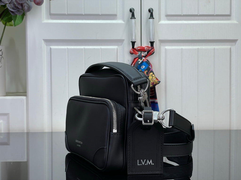 Louis Vuitton crossbody bag side view with zip pockets and adjustable shoulder strap