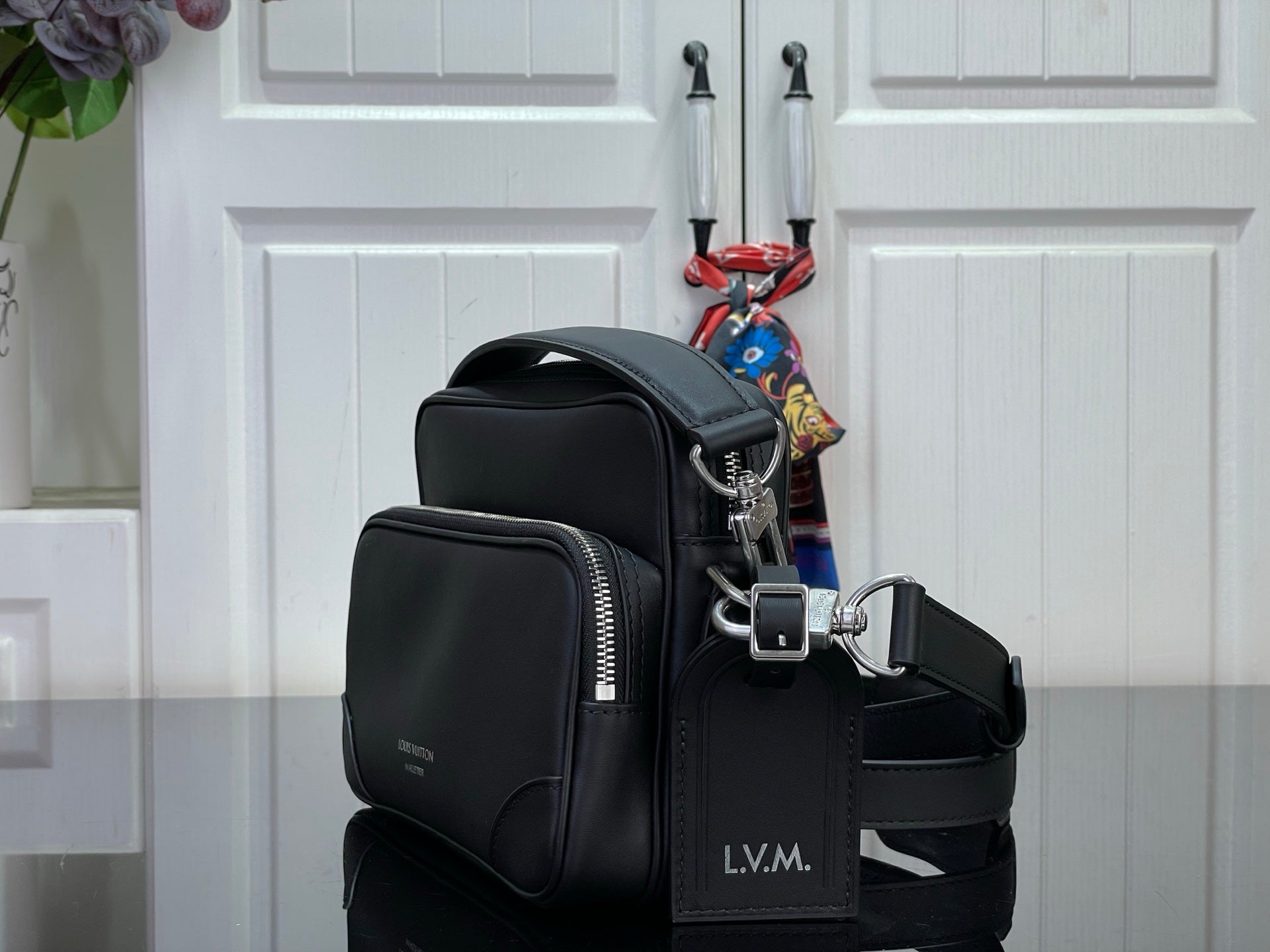 Louis Vuitton crossbody bag side view with zip pockets and adjustable shoulder strap
