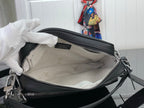 Black handbag with zipper opening and light logo-lined interior