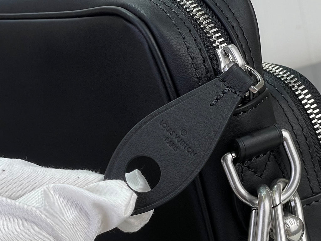 Louis Vuitton crossbody bag close-up of zipper track and leather strap ring