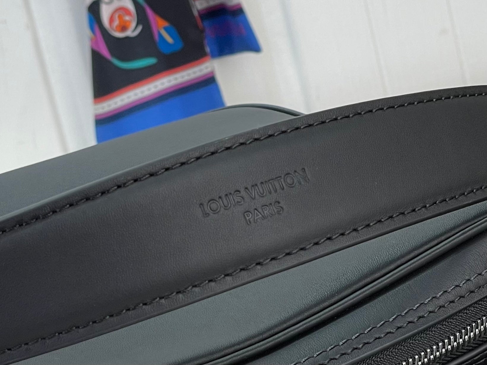 Louis Vuitton “PARIS” embossing on dark black strap with stitched edge