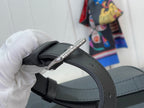 Black handbag strap with silver metal clasp