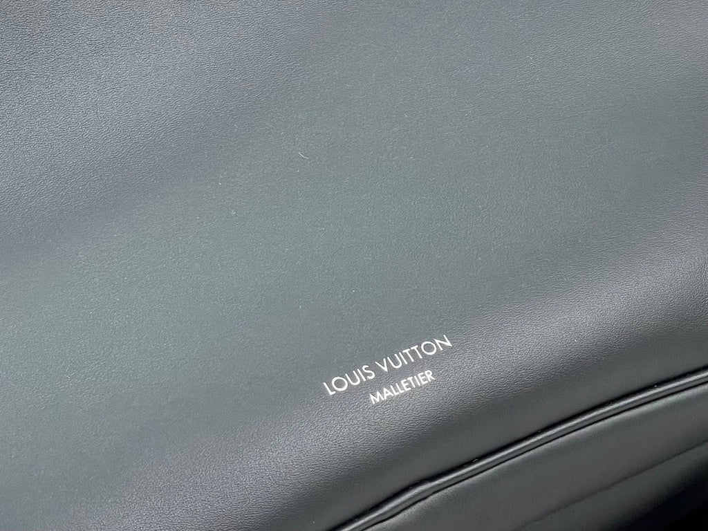 Leather bag panel with embossed Louis Vuitton Maullertine logo stamp.