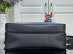 Dark leather crossbody bag with structured top edge and shoulder strap.